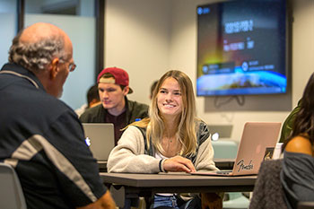 Photo of a student listening to a professor. Links to Gifts That Pay You Income