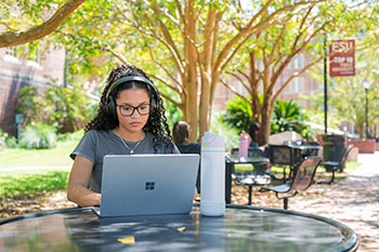 Photo of a student studying outside. Links to What to Give