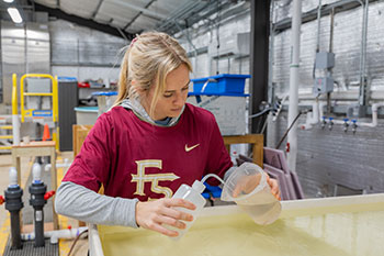 Photo of a student putting water in a cup. Links to Gifts by Will