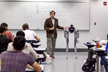 Photo of a professor showing a robot to students. Links to Donor-Advised Funds